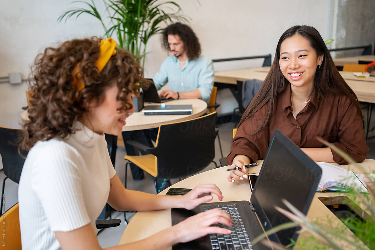 Student working at her laptop with a Certified Microsoft Office instructor